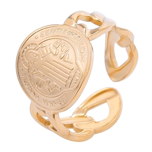 Detailed shot of golden St. Benedict Medal ring with adjustable Cuban link band