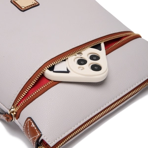 Detail view of grey lychee leather crossbody bag with red lining and phone storage