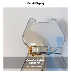 Detailed macro of cat-shaped silver patent leather bag with gold buckle and stitching