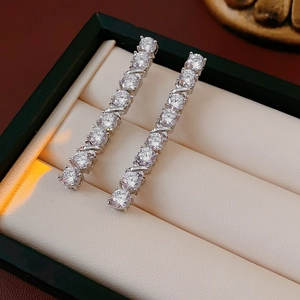 Macro detail of elegant silver-tone drop earrings with sparkling clear cubic zirconia stones
