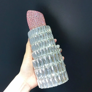 Detail of lipstick shaped evening clutch bag with pink rhinestones and silver crystals