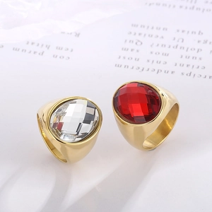 Detailed macro of vintage gold rings with large oval faceted glass in clear and red colors