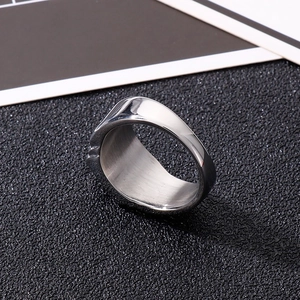 Close-up of a wide silver titanium steel ring featuring a polished mirror finish on a black background