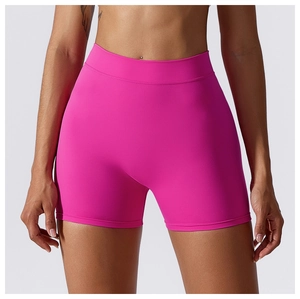 Detail of high-waisted seamless yoga shorts in bright pink featuring elastic waistband