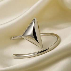 Macro shot of silver stainless steel open bracelet with large 3D triangle geometric detail