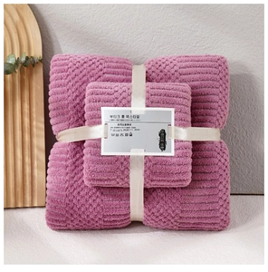 Detail of coral fleece towel set in mauve with pineapple texture and gift ribbon packaging