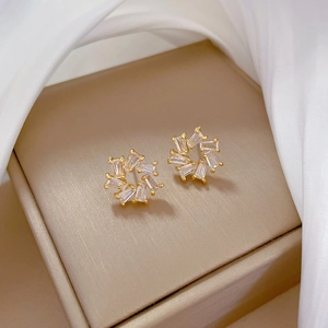 Luxe titanium steel circular flower stud earrings with zircon in a gold jewelry box