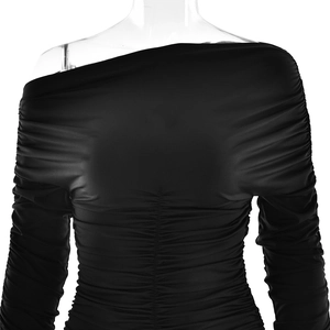 Macro detail of the elegant ruched texture and fitted long sleeves on this black dress