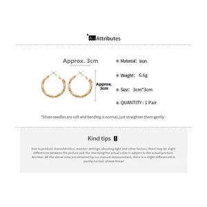 Detail view of twisted geometric rose gold earrings with size and weight parameters