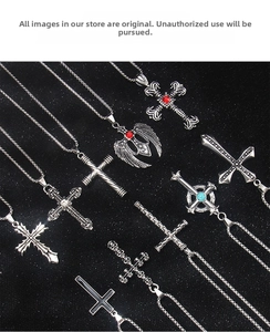 Close-up of vintage punk cross necklaces with gothic engravings and gemstone details
