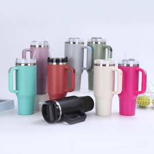 Multiple 40oz insulated tumblers with handles and straws in various pastel colors