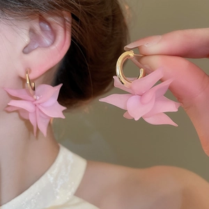 Detail of pink acrylic petal C-shape earrings with matte finish and golden metal hoops