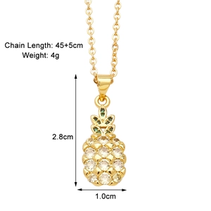 Detailed view of a gold pineapple pendant necklace with green and clear cubic zirconia