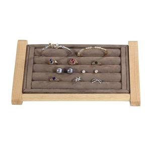 Solid wood jewelry display stand with brown velvet slots for rings and earrings