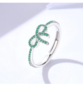 Macro shot of S925 sterling silver bow ring featuring sparkling green zircon stones
