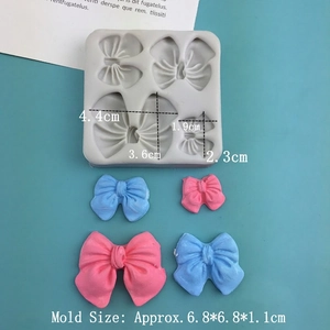 Silicone bow mold for fondant and chocolate with 4 sizes of butterfly shapes on blue surface