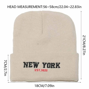 Detail of New York embroidery on beige knitted beanie showing dimensions and texture