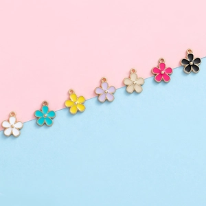Set of colorful enamel flower charms in seven shades for DIY jewelry and crafts
