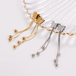 Boucles d'oreilles papillon élégantes avec longues chaînes et perles sur un plateau