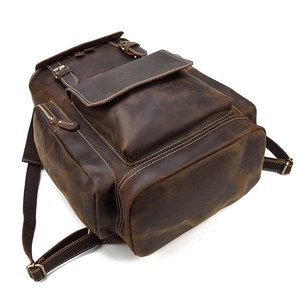 Detailed view of dark brown crazy horse leather backpack with vintage stitching and pockets