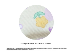 Close-up of soft plush fabric with yellow flower prints showing fine texture and quality