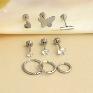 Detail set of silver stainless steel earrings featuring heart, butterfly and stud designs
