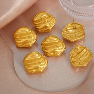 Detailed view of irregular 18k gold plated stainless steel earrings with natural texture