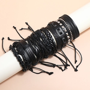 Set of 12 black multilayer braided leather bracelets with metal studs and bird pendant
