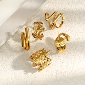 Detailed close-up of 18K gold plated rings featuring floral and abstract textured designs