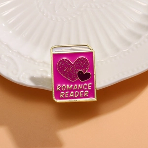 Pink glitter enamel book brooch with Romance Reader text on white vintage plate