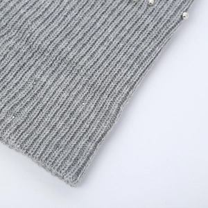 Detailed view of grey knit beanie with elegant silver pearl accents and ribbed texture
