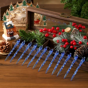 Detailed macro view of twelve blue spiral icicle ornaments arranged on a rustic wooden box