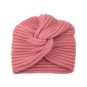 Detail showing the thick knit texture and crossover twist of the pink turban hat