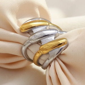 Modern dual-tone layered ring in 18K gold and silver plating on beige silk
