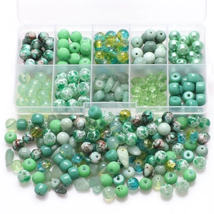 DIY jewelry kit featuring mixed green glass and stone beads in a 10-grid storage box