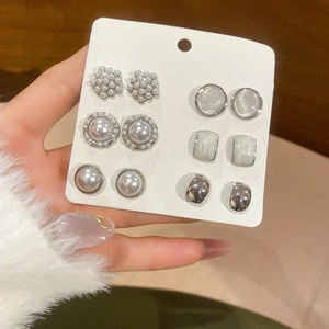 Detailed view of a 6-pair silver needle earring set featuring pearls and zircon accents