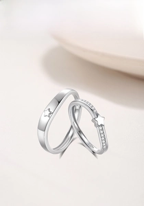 Macro shot of S925 sterling silver couple rings with star motif and pavé cubic zirconia
