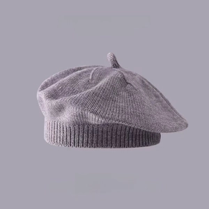 Detail shot of a grey knitted wool beret with high-quality textured fabric for kids