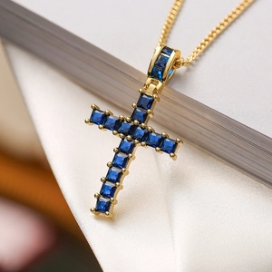 Luxury gold plated cross necklace with square blue gemstone on a minimalist chain