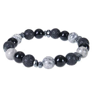 Macro detail of beaded bracelet showing black agate, porous lava rock, and gray map stone