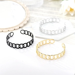 Detailed view of fashionable linked circle open bangles in gold, silver, and black.