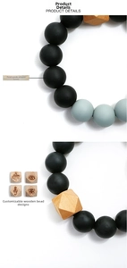 Detail of food-grade silicone beads and custom engraved geometric wooden bead
