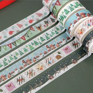 Detail of five Christmas themed washi tapes featuring festive trees, Santa and reindeer