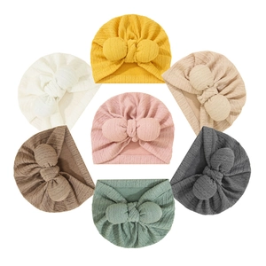 Set of seven newborn baby turban hats with rabbit ear bows in various colors