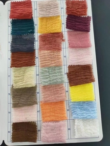 Texture swatches of pleated cotton linen scarves in 24 colors with fringed edges