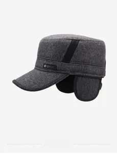 Detail view of winter flat cap showing grey twill fabric texture and ear protection flap