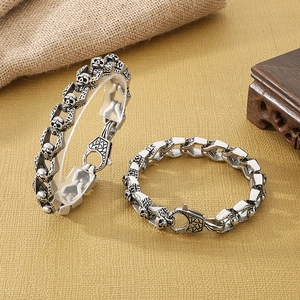 Retro stainless steel skull bracelet for men featuring a vintage silver finish and lobster clasp