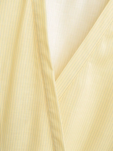 Close-up of a V-neck wrap top showing fine yellow stripes and natural fabric texture
