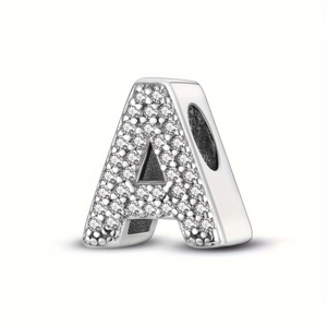 Macro detail of silver letter A bead charm with micro-pave clear zircon stones