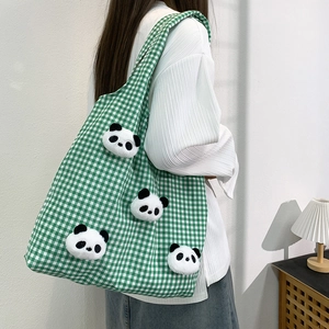 Green and white plaid canvas tote bag with 3D plush panda dolls on model shoulder